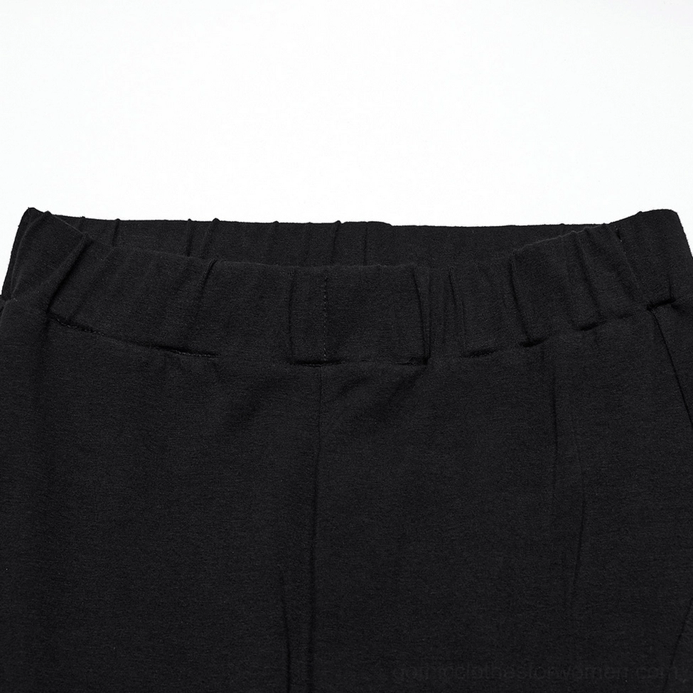 Black ruffle flare gothic pants elastic waistband close-up showing elastic band construction and precise stitching