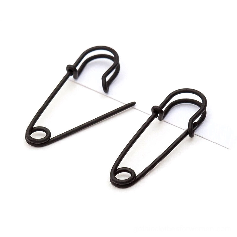 Black matte safety pin cross ear stud earrings - gothic punk jewelry flat lay close-up
