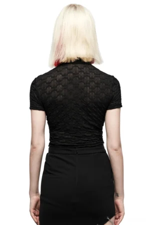 Black geometric lace crop top rear view on model, showing cropped hem and short sleeves with translucent fabric detail