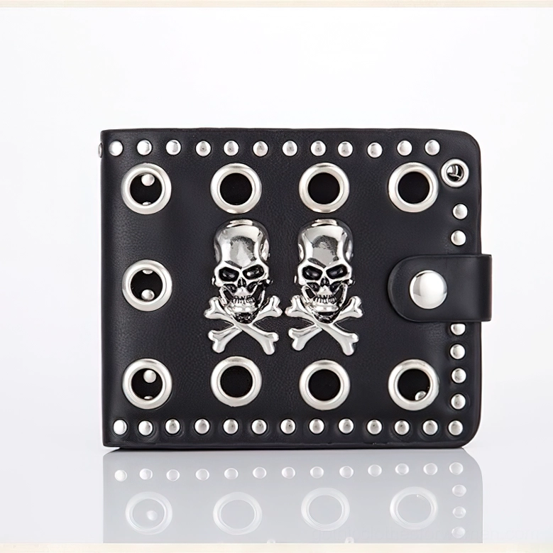 Punk gothic wallet front flat lay displaying dual silver skulls and metal grommet accents