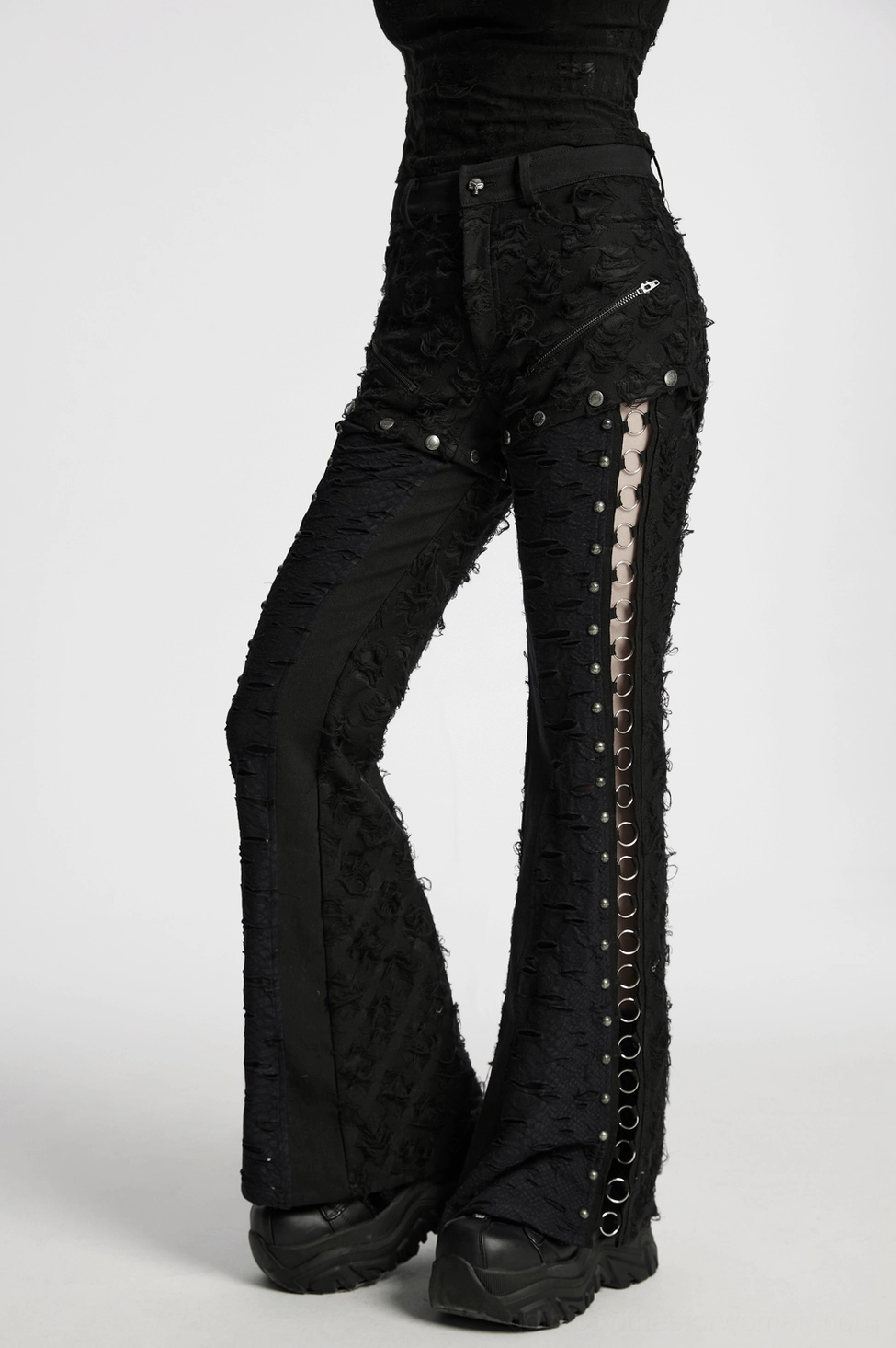 Black gothic split pants flat lay showing tattered rose texture and metal hardware
