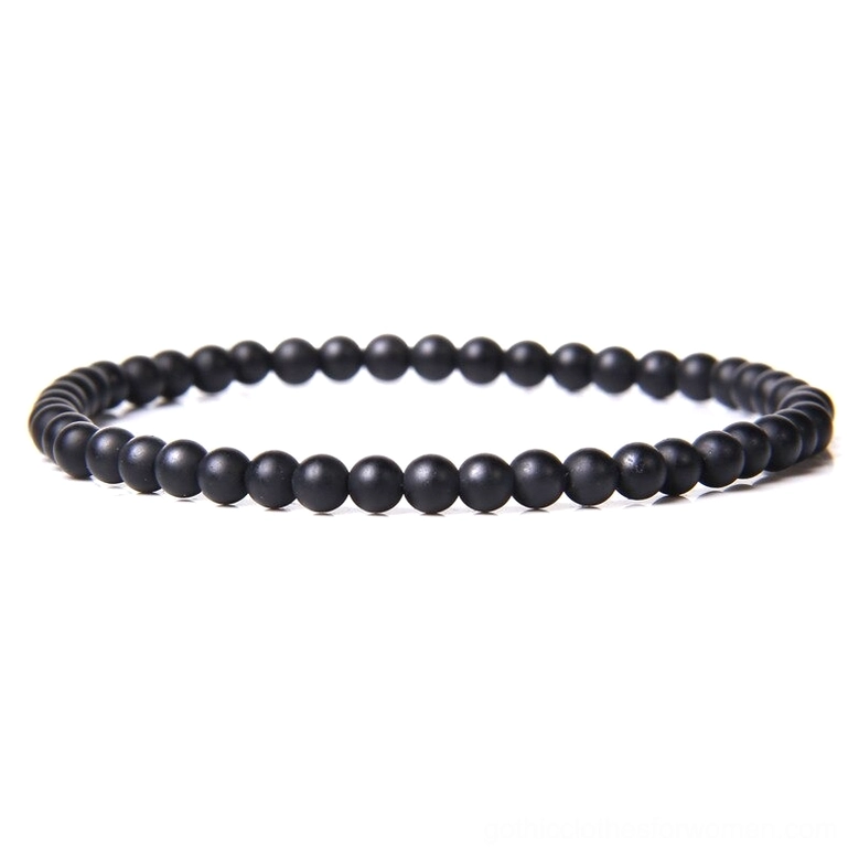 Single strand black stone beaded bracelet with polished smooth agate beads close-up flat lay view gothic minimalist design