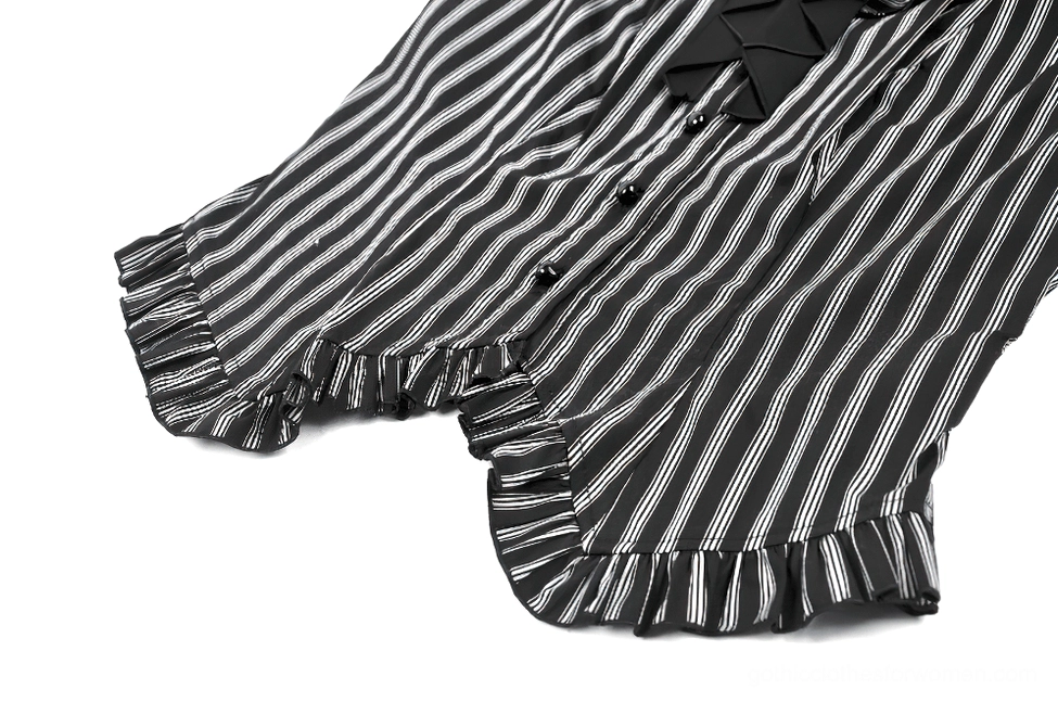 Close-up detail of ruffled edges and black-white vertical stripes with front button closure