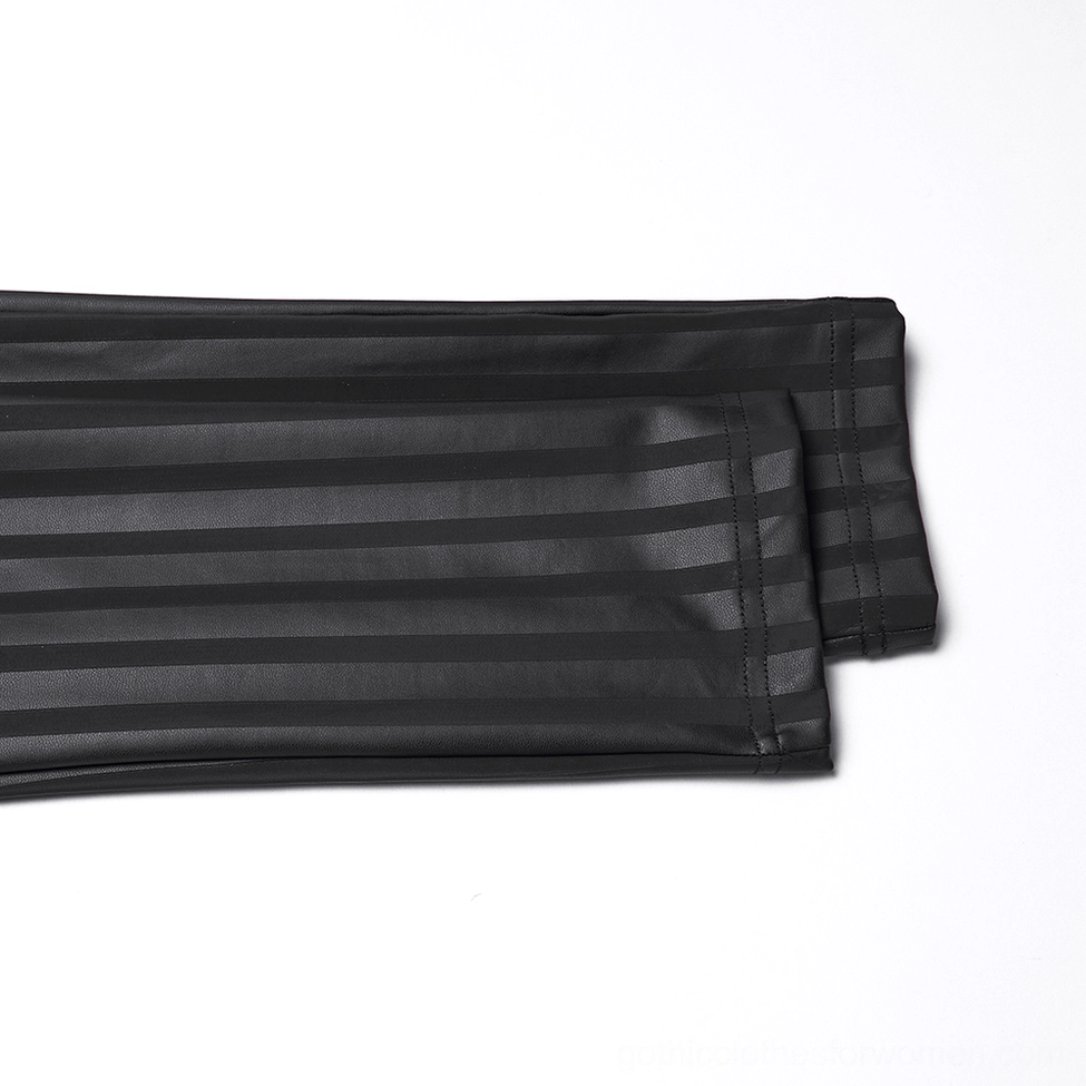 Black striped gothic leggings neatly folded, showcasing vertical stripe pattern and matte rubberized polyurethane material texture