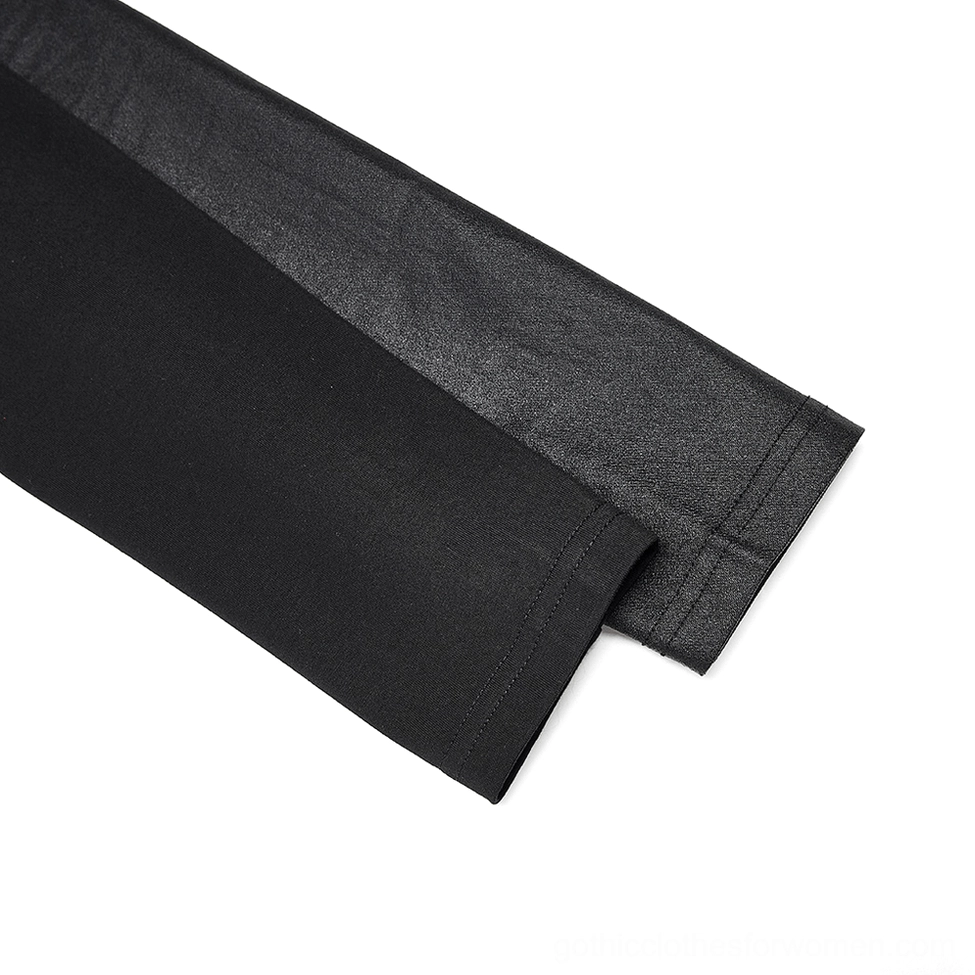 Mixed fabric sleeve detail on black studded crop top, smooth leather panel and cuff close-up