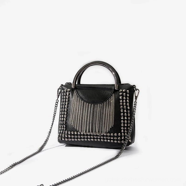 Front view of gothic rivet tassel bag with metal top handle and adjustable chain strap