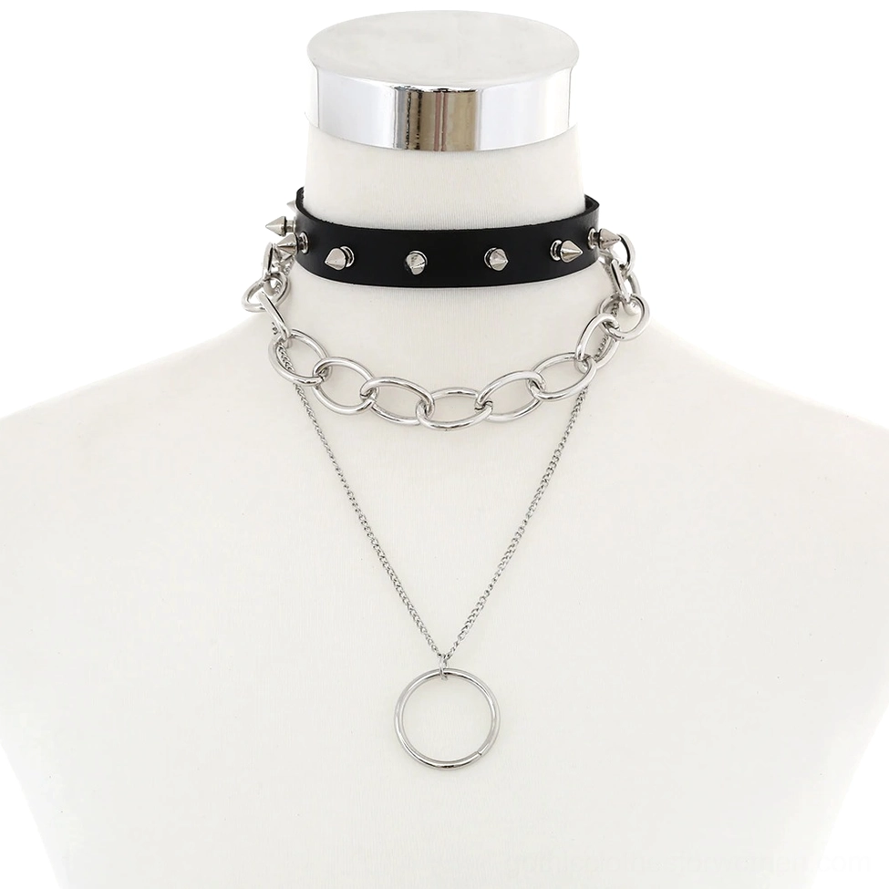 Black studded leather gothic choker necklace with dual silver chain layers and circular pendant, front flat lay view