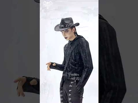 Black metal studded gothic cowboy hat half-body view on male goth model in all-black studded outfit