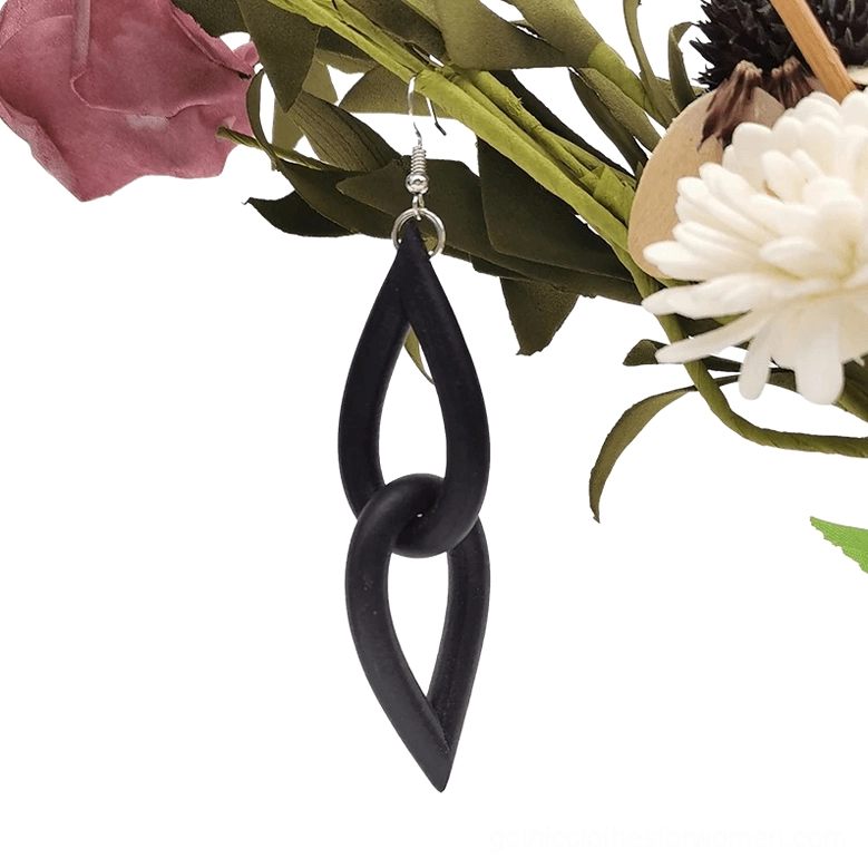 Single black teardrop rubber earring close-up showcasing matte silicone texture, interlocking link design, and gothic minimalist aesthetic