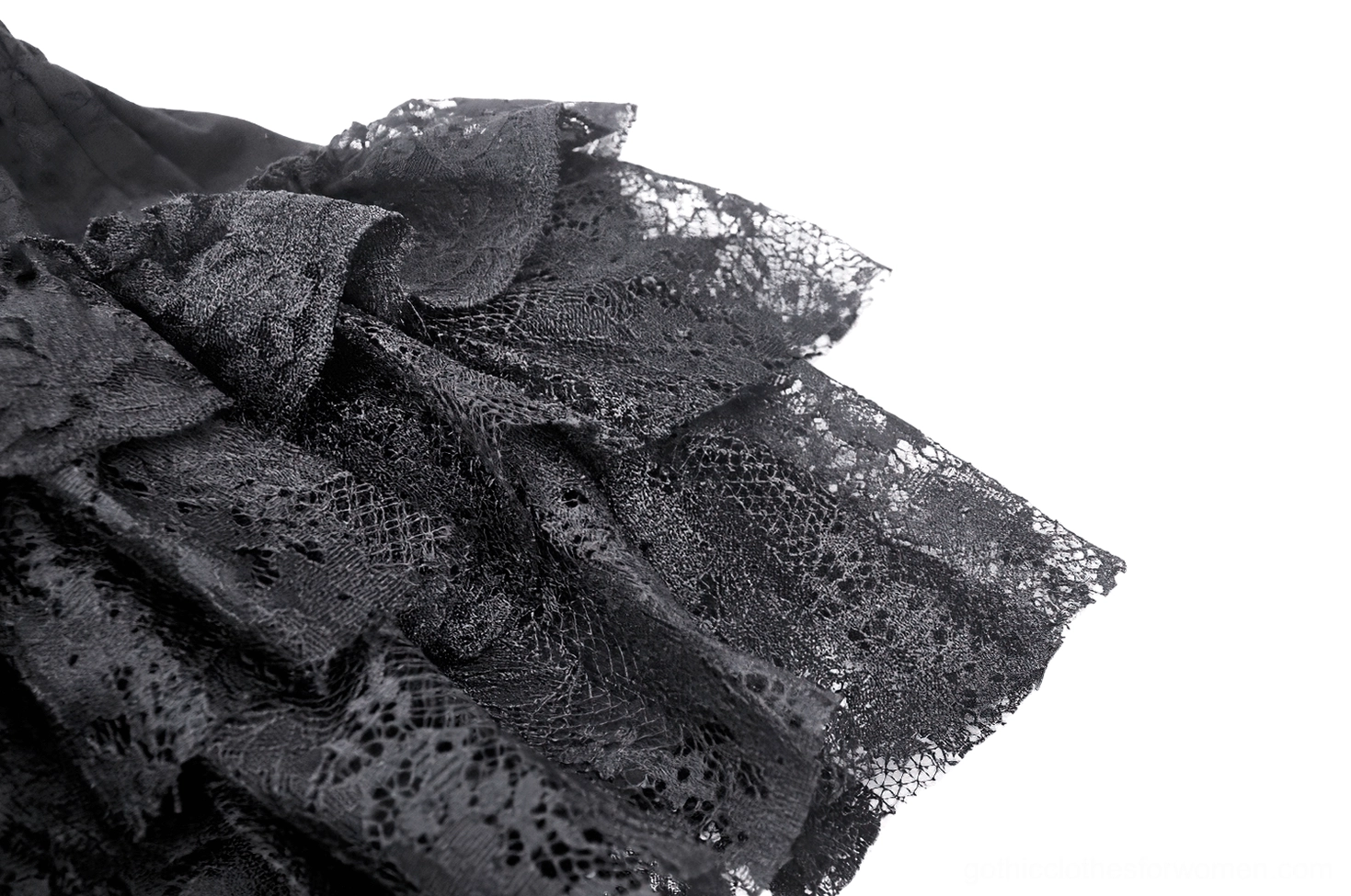 Black gothic mini skirt hem detail - layered ruffles creating movement and theatrical drama