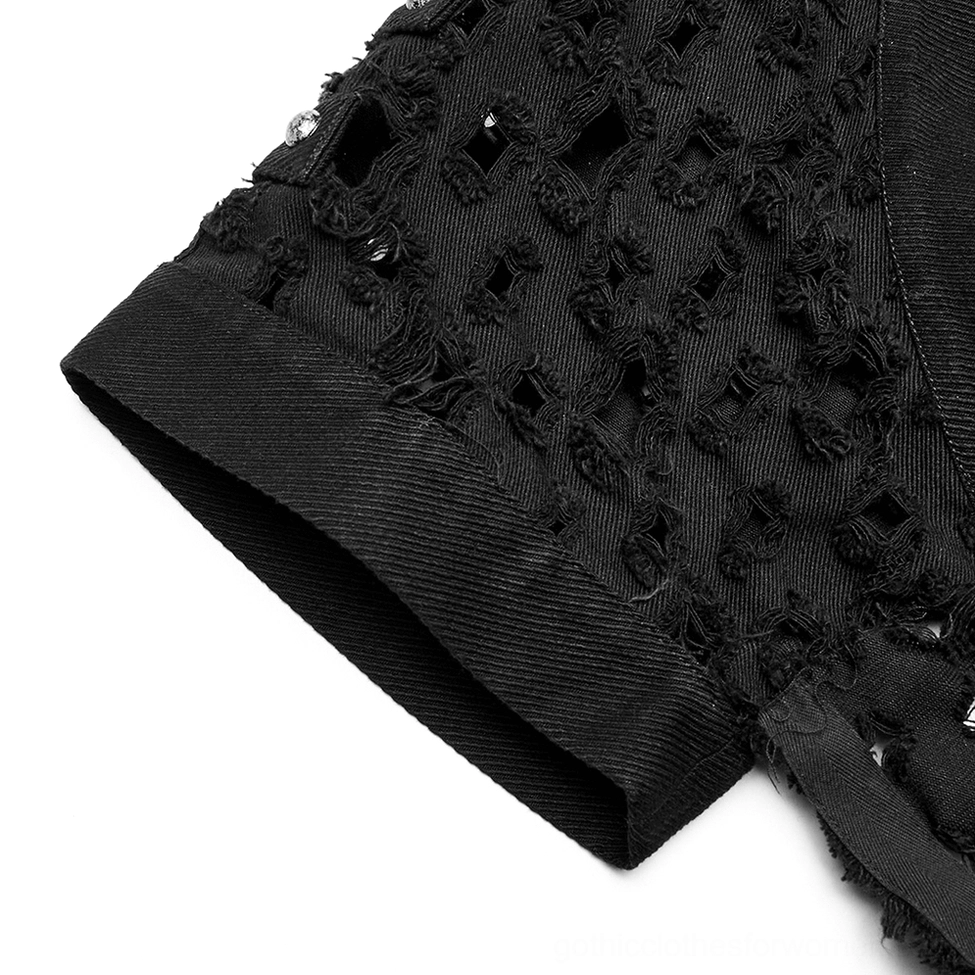 Close-up detail of black twill fabric showing sleeve edge cutouts and frayed raw edges on cape cardigan