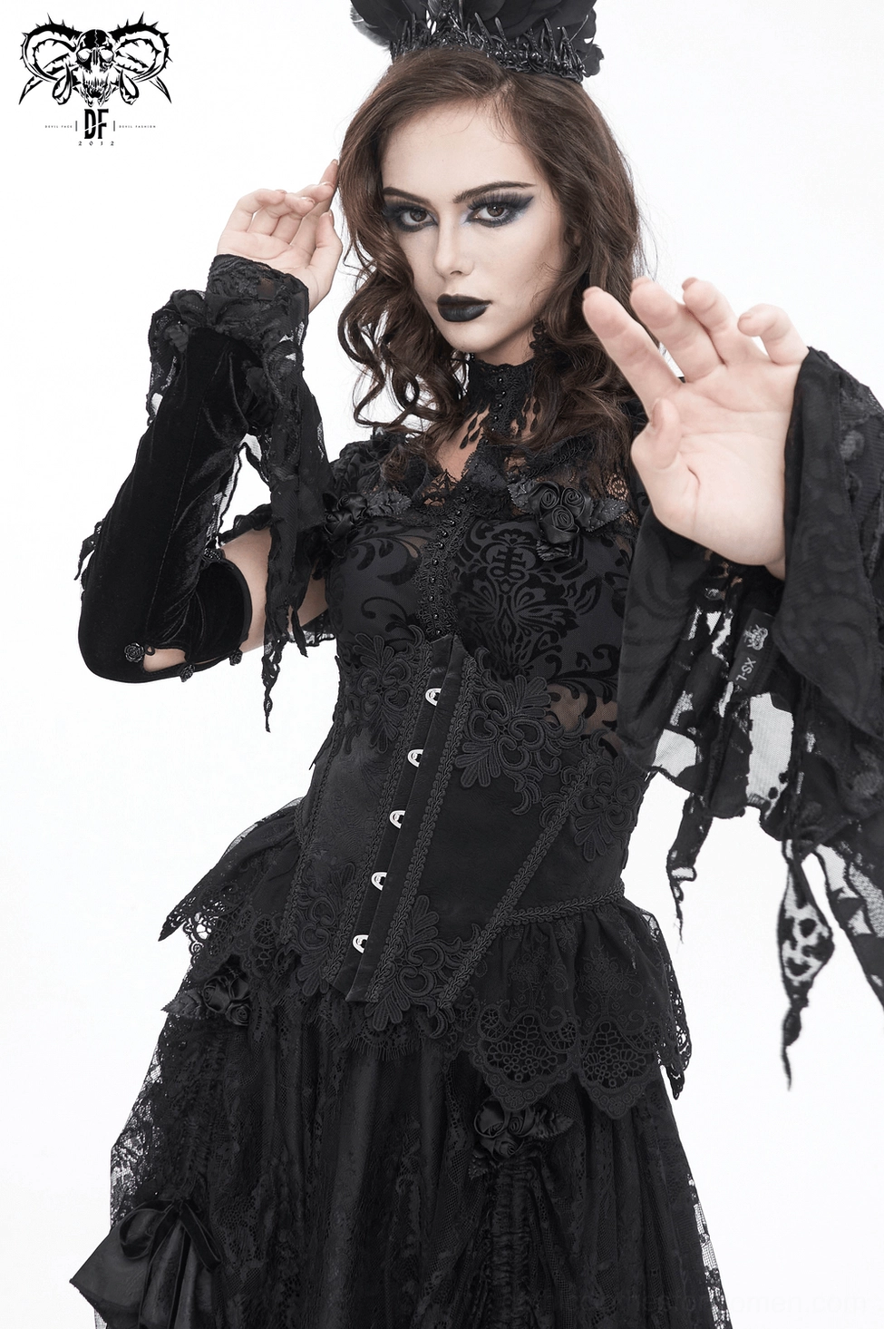 Detailed view of black underbust corset hook fasteners and ornamental lace pattern on gothic fashion model