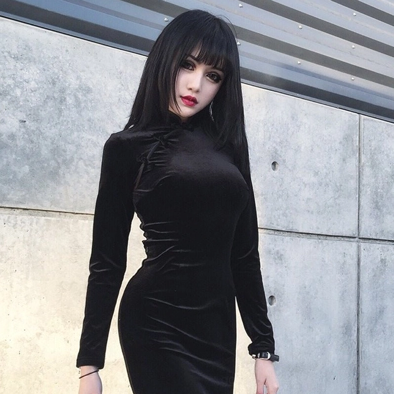Black velvet cheongsam dress worn by gothic model in industrial setting