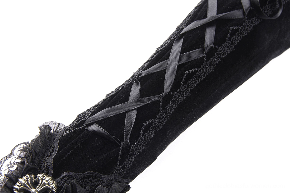 Single black velvet fingerless glove side close-up flat lay, showcasing cross lace-up pattern and embroidered lace edge with metal cuff decoration