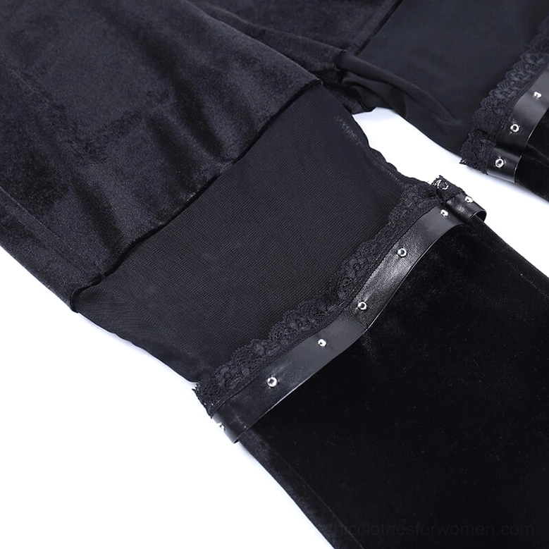 Black velvet flare trousers displaying ankle-length proportions, mesh panels and studded leather embellishments