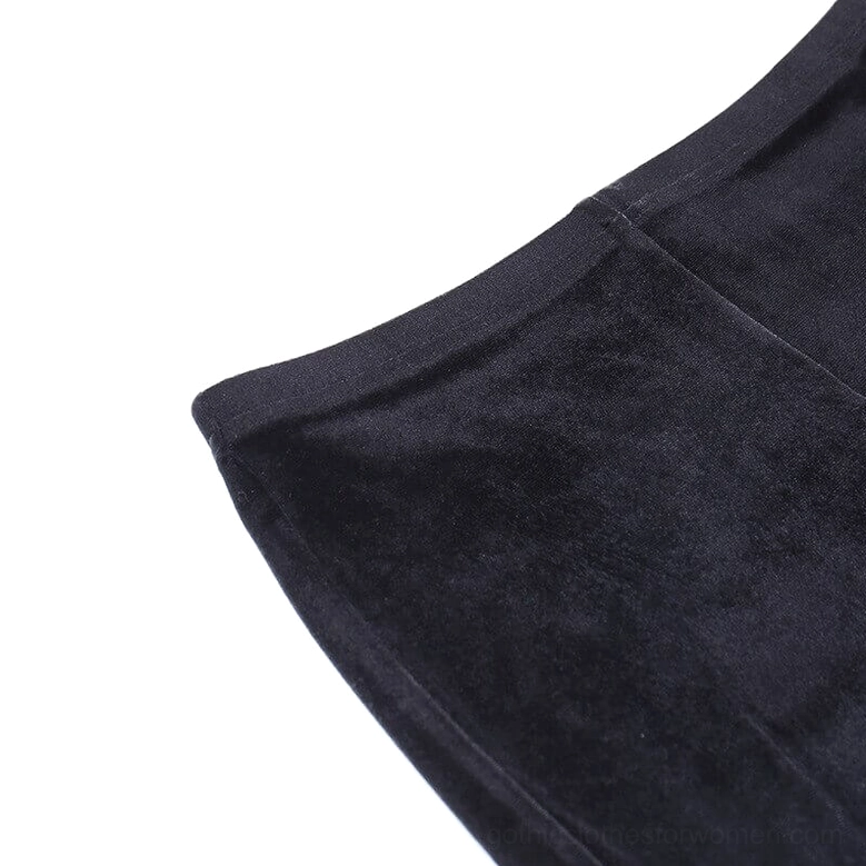 High-waisted black velvet flare pants featuring mesh thigh inserts and gothic-inspired studded trims on model