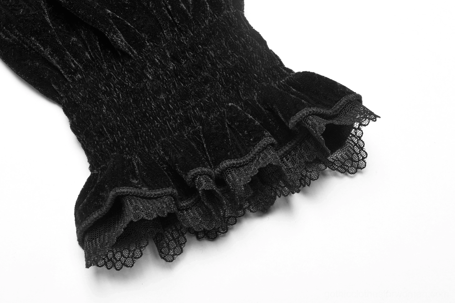 Close-up detail of black velvet Gothic blouse cuff showing shirred velvet texture and delicate ruffled lace trim with elasticated edge