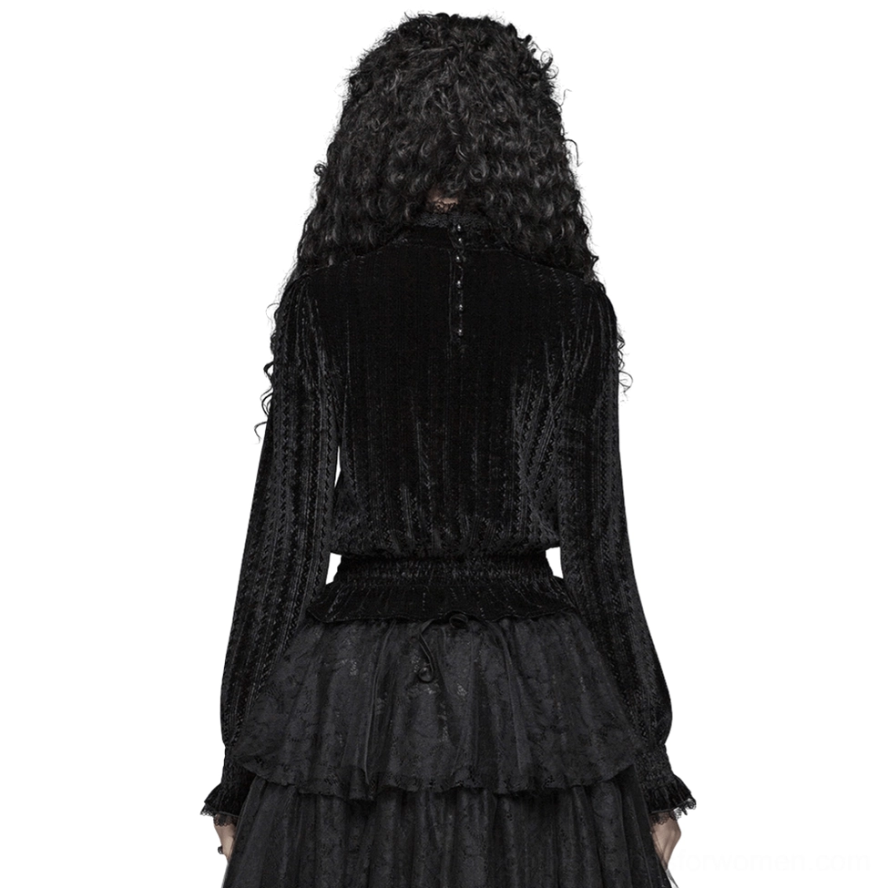 Back view of black Gothic velvet blouse displaying back button closure, shirred waist, and ruffled collar detail on female model