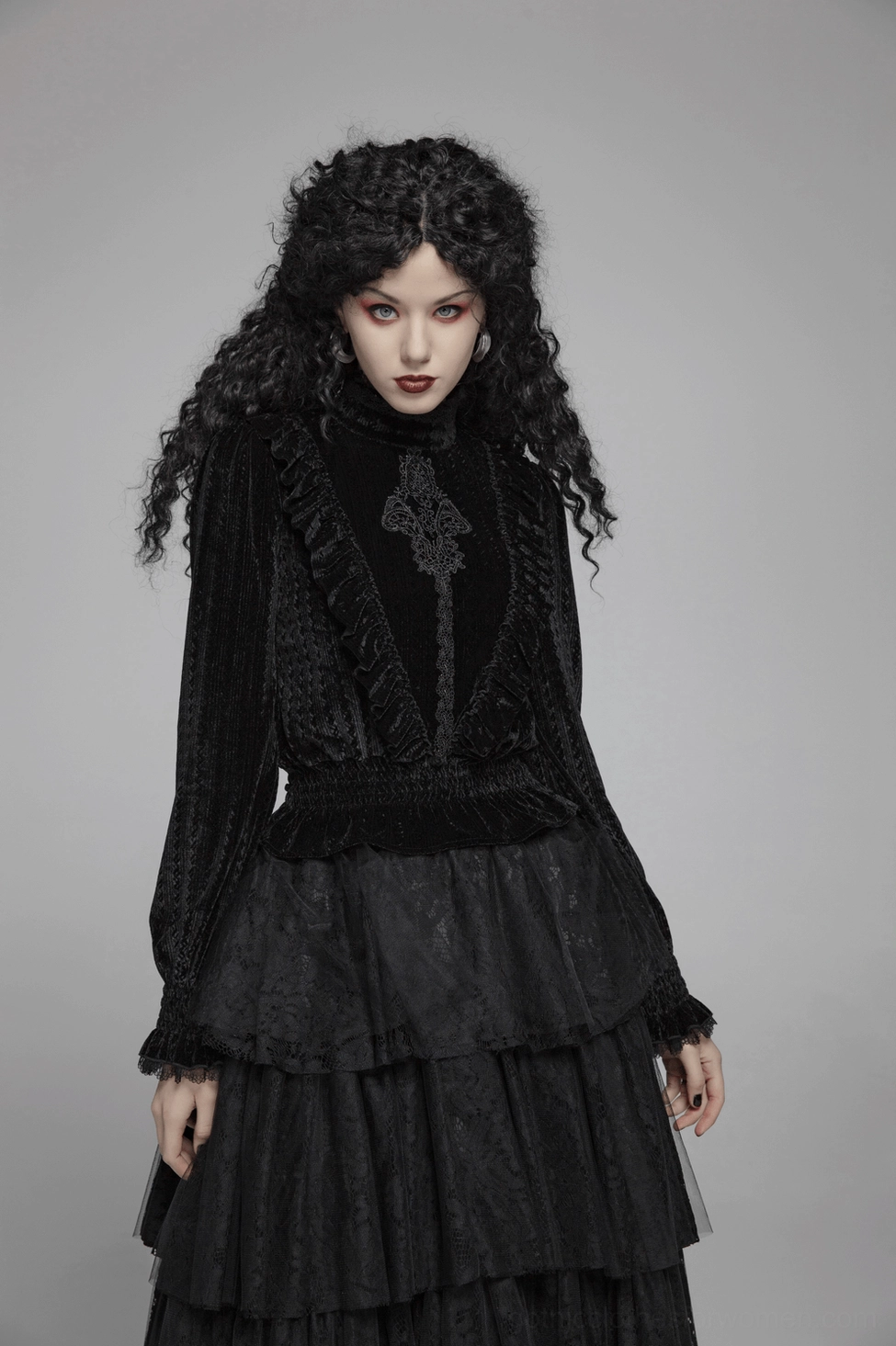 Black velvet Gothic blouse flat lay or styled detail shot emphasizing the dramatic ruffled collar and overall silhouette design