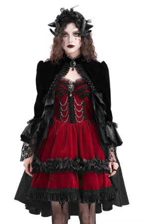 Black velvet gothic bolero jacket with lace ruffles, stand collar, and gem brooch—front view on model with gothic styling
