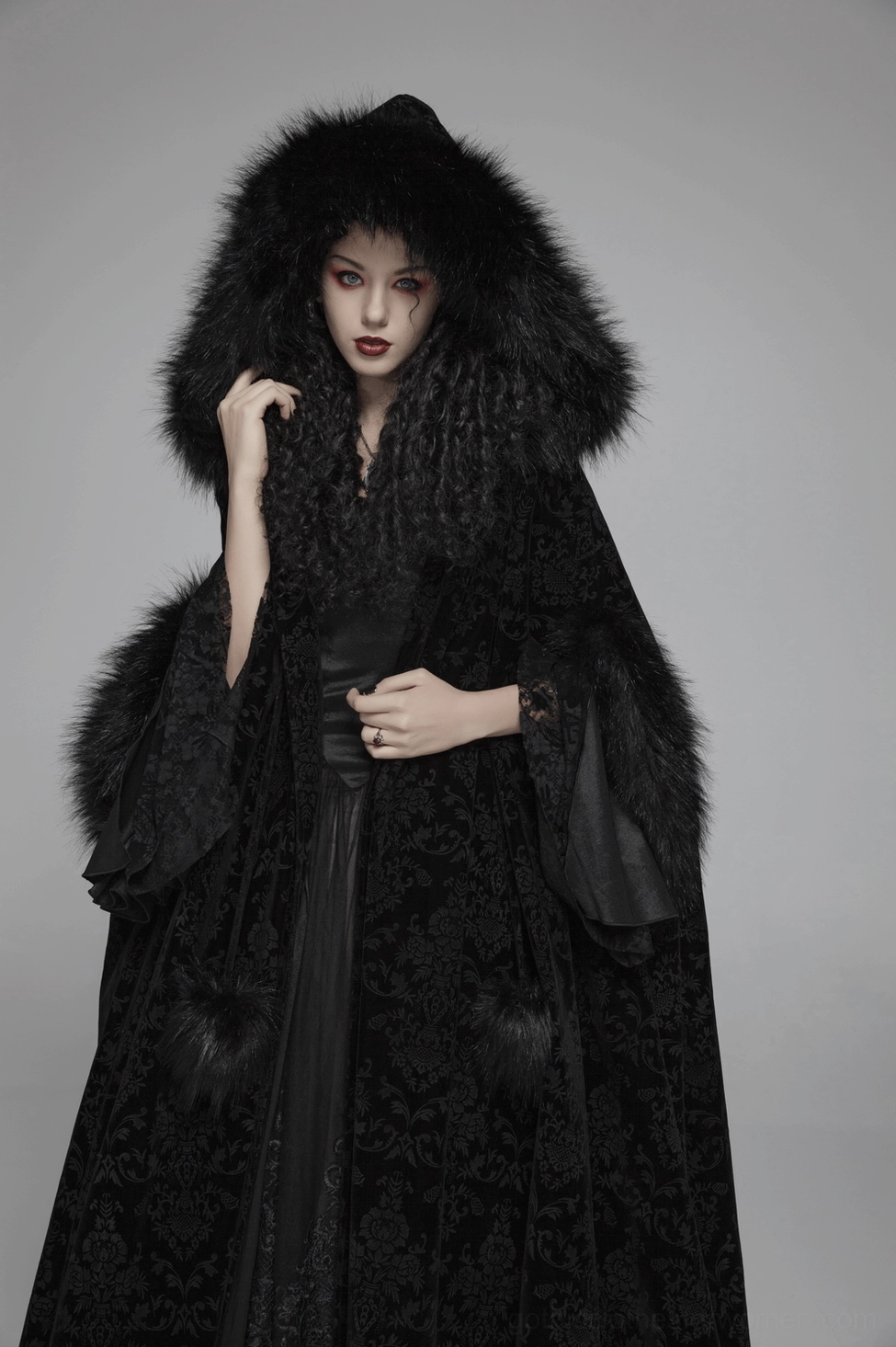 Black velvet Gothic cloak dramatic full-length view highlighting theatrical presence and flowing silhouette