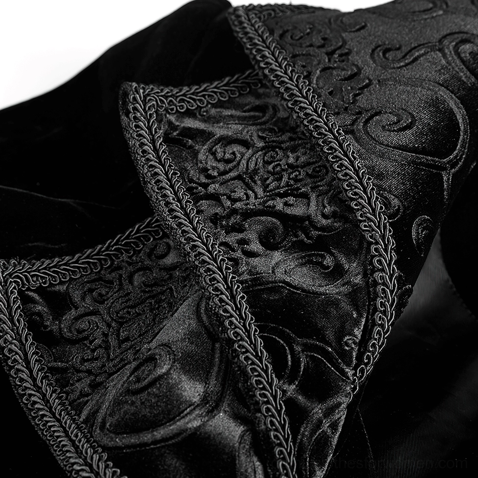 Macro close-up of gothic coat cascading collar detail showing embossed embroidery and braided edge trim