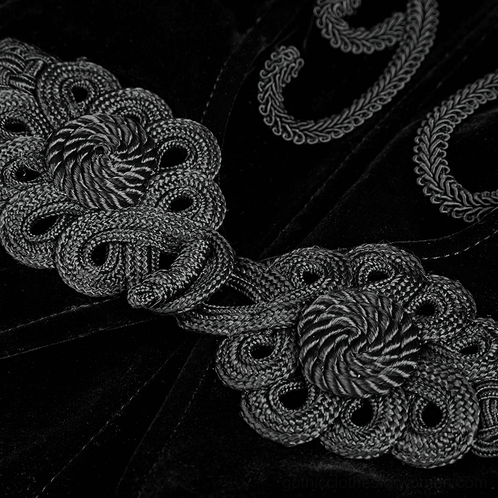 Close-up macro photography of black velvet gothic coat embroidery trim showing braided rope pattern