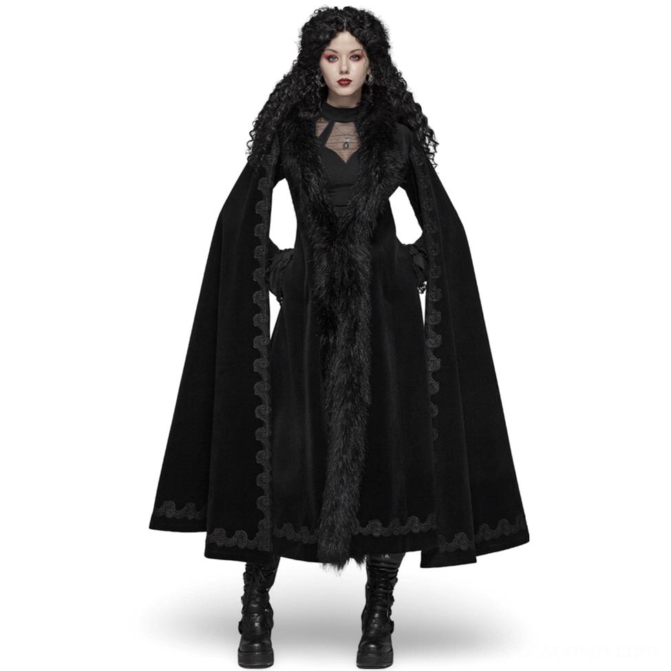 Black velvet gothic long coat with faux fur trim, cape sleeves, and lace-up back worn by model - front view