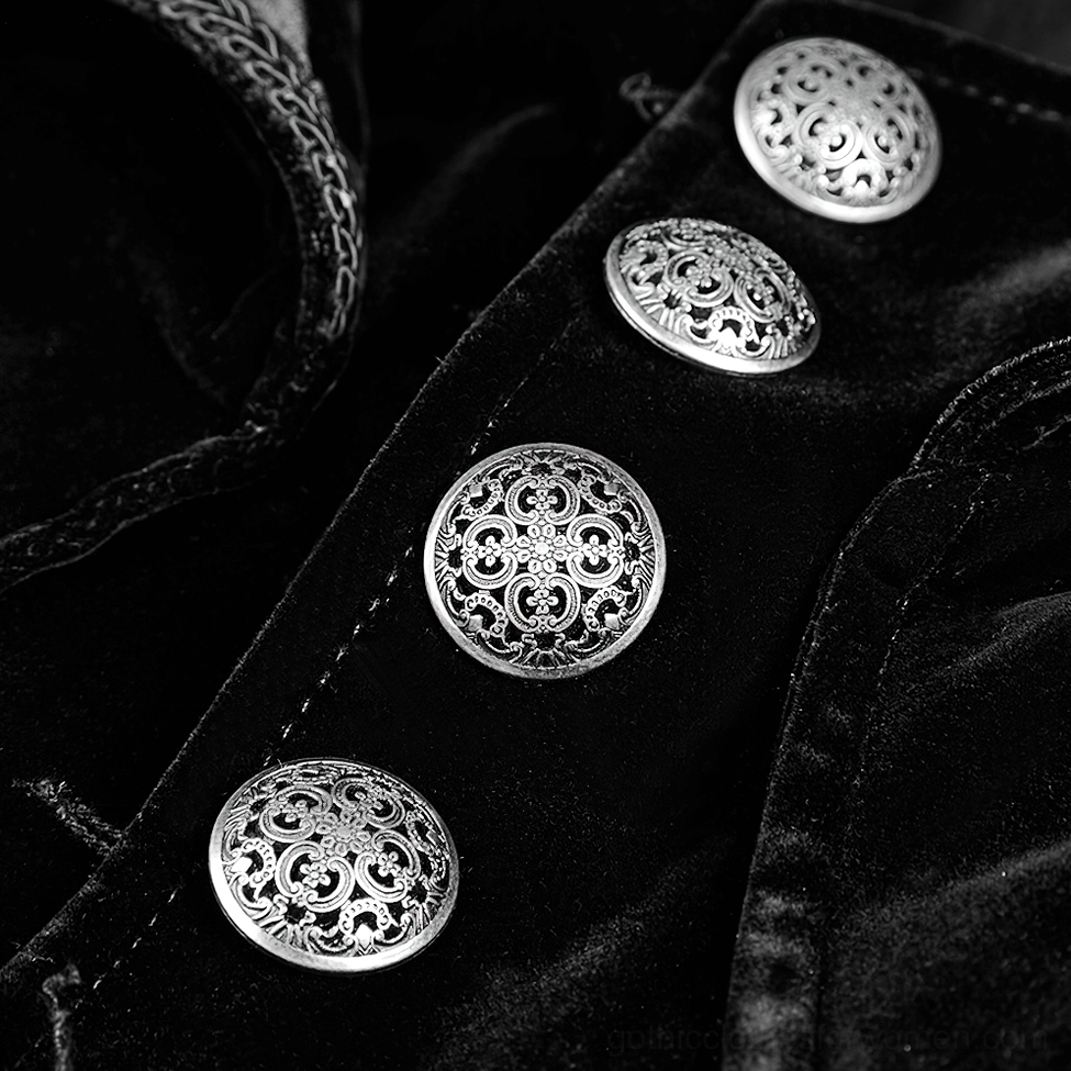 Close-up detail of carved silver metal buttons on black velvet gothic trench coat with neat stitching