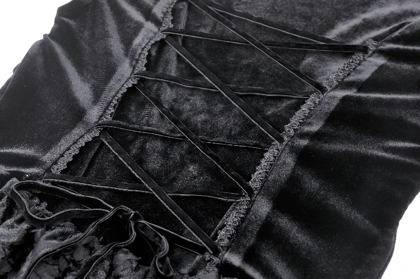 Close-up detail of gothic dress back corset lacing showing velvet fabric, horizontal lace-up construction with metal eyelets, and textured fabric accents