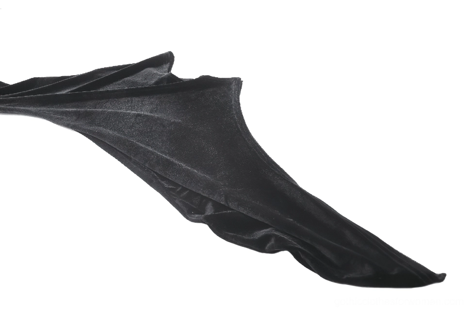 Close-up detail of black velvet gothic dress bell sleeve showing extra-long flared velvet drape