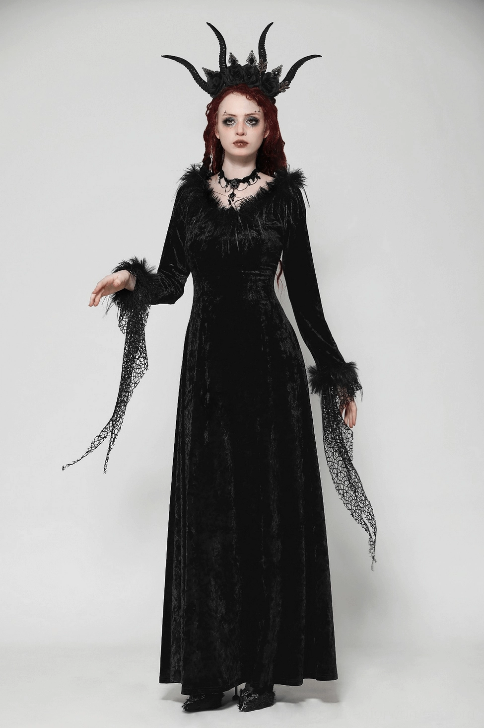 Black velvet gothic dress detail showing feathered trim at neckline, lace accents, and overall dress construction