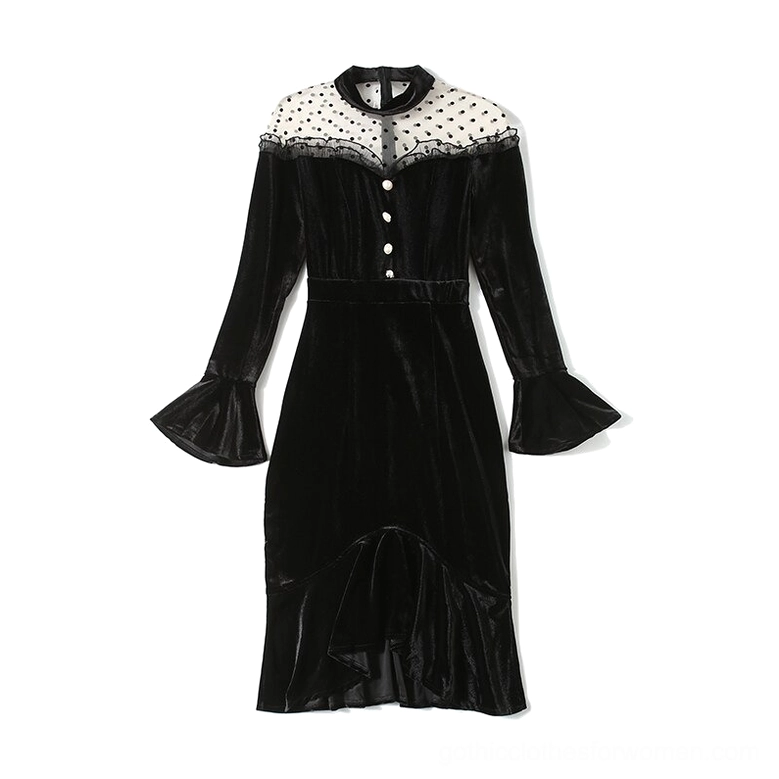 Black velvet gothic midi dress hanging flat lay showing stand collar, flared cuffs, and ruffled fishtail hem detail on white background