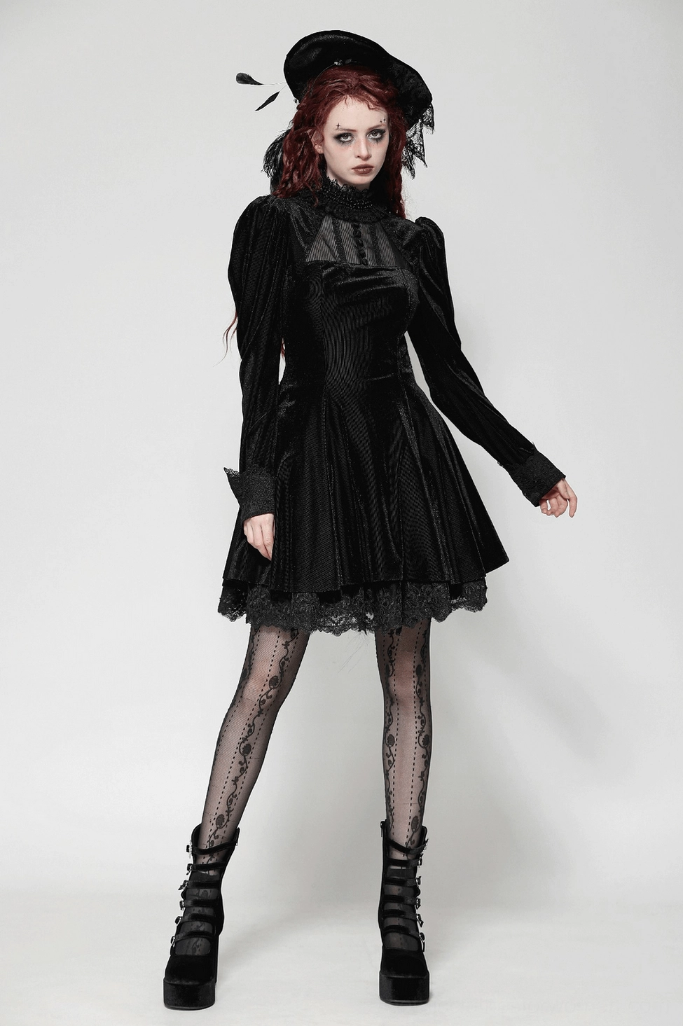 Black velvet gothic mini dress showing front design with lace trimmed collar, sheer bust section, and structured bodice fit