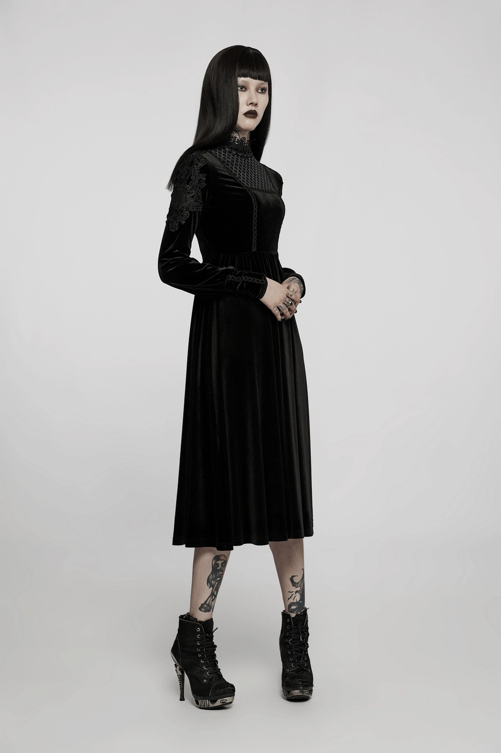 Full body front view of black velvet gothic midi dress with lace collar and statement sleeve details