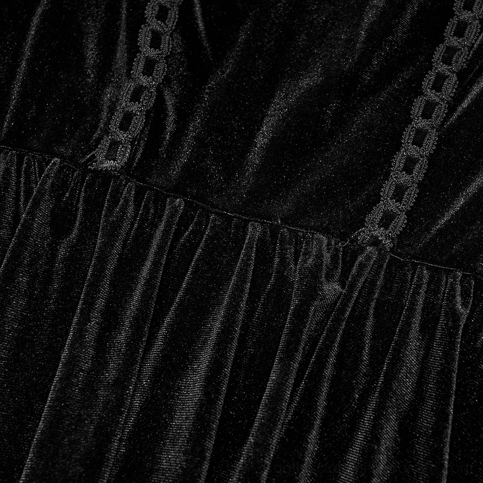 Skirt detail close-up of black velvet gothic dress showing chain-style fabric trim and gathered texture