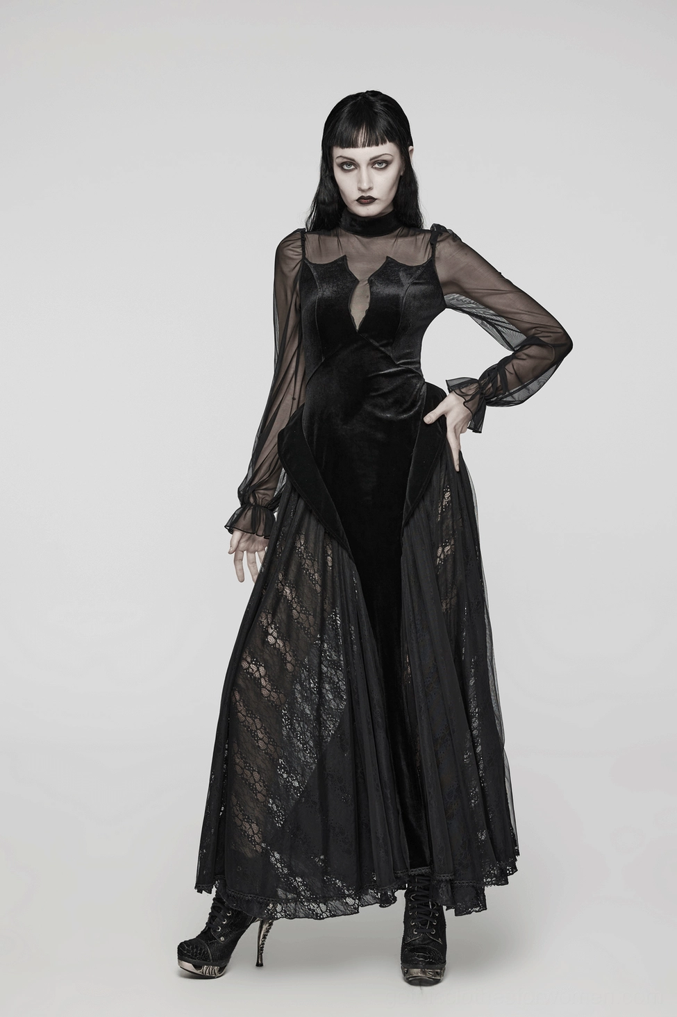 Three-quarter view of black velvet mesh gothic dress showing lace trim hem, mesh layers, and overall dress construction