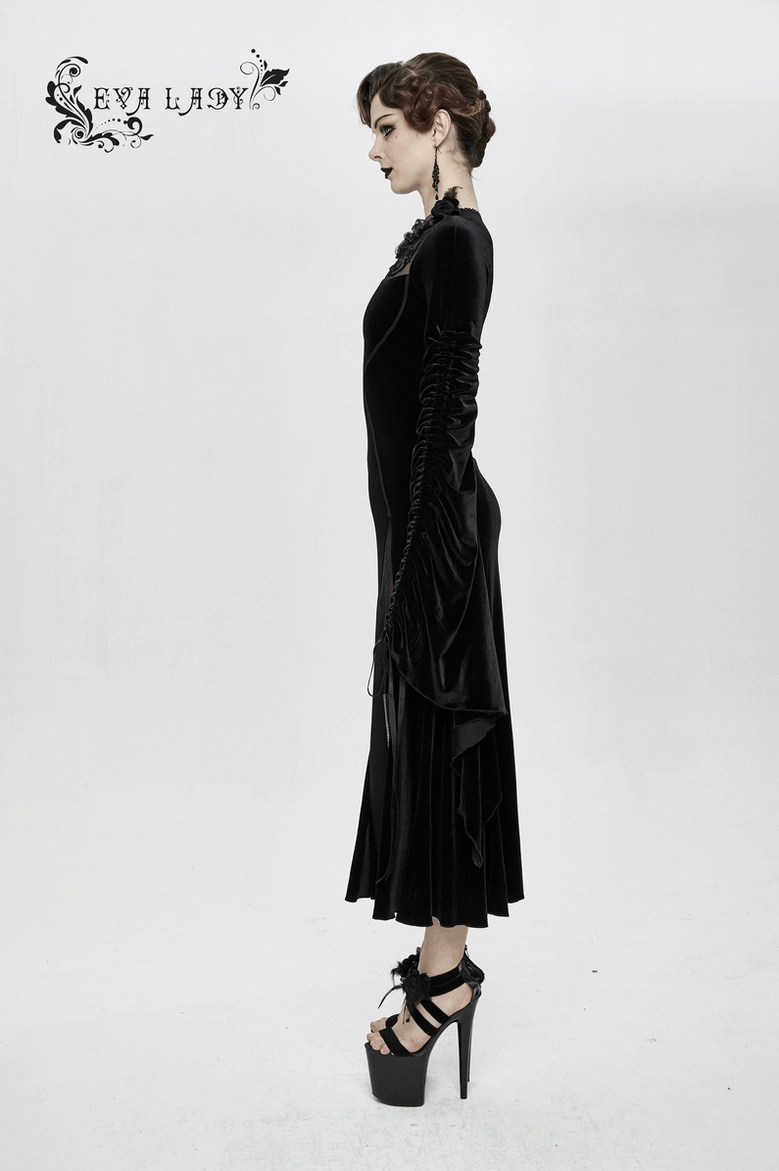Three-quarter view of black velvet gothic dress showing filigree details and bell sleeve drama