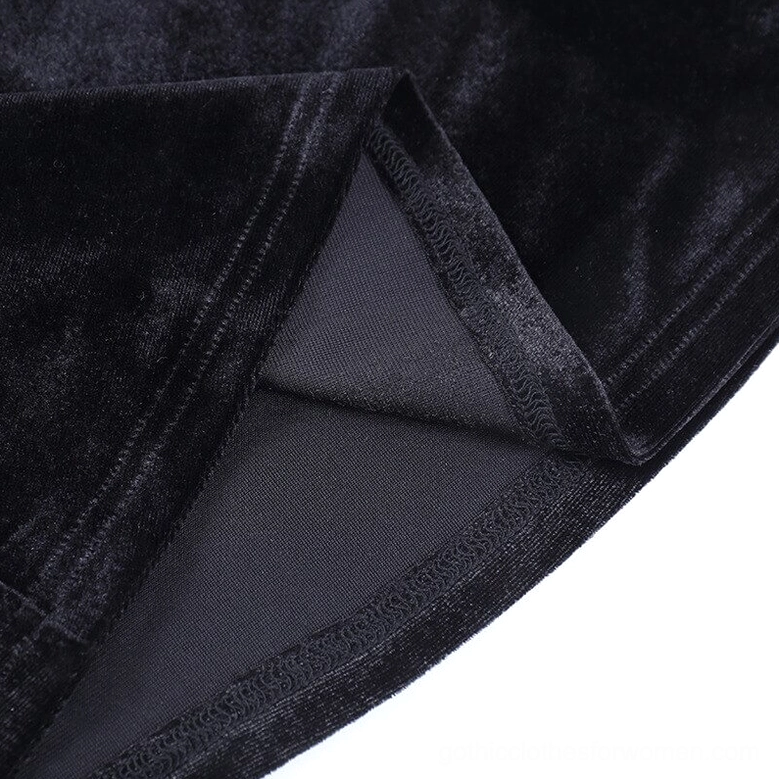 Close-up view of black velvet flare pants showing mesh thigh insert construction and studded leather trim quality