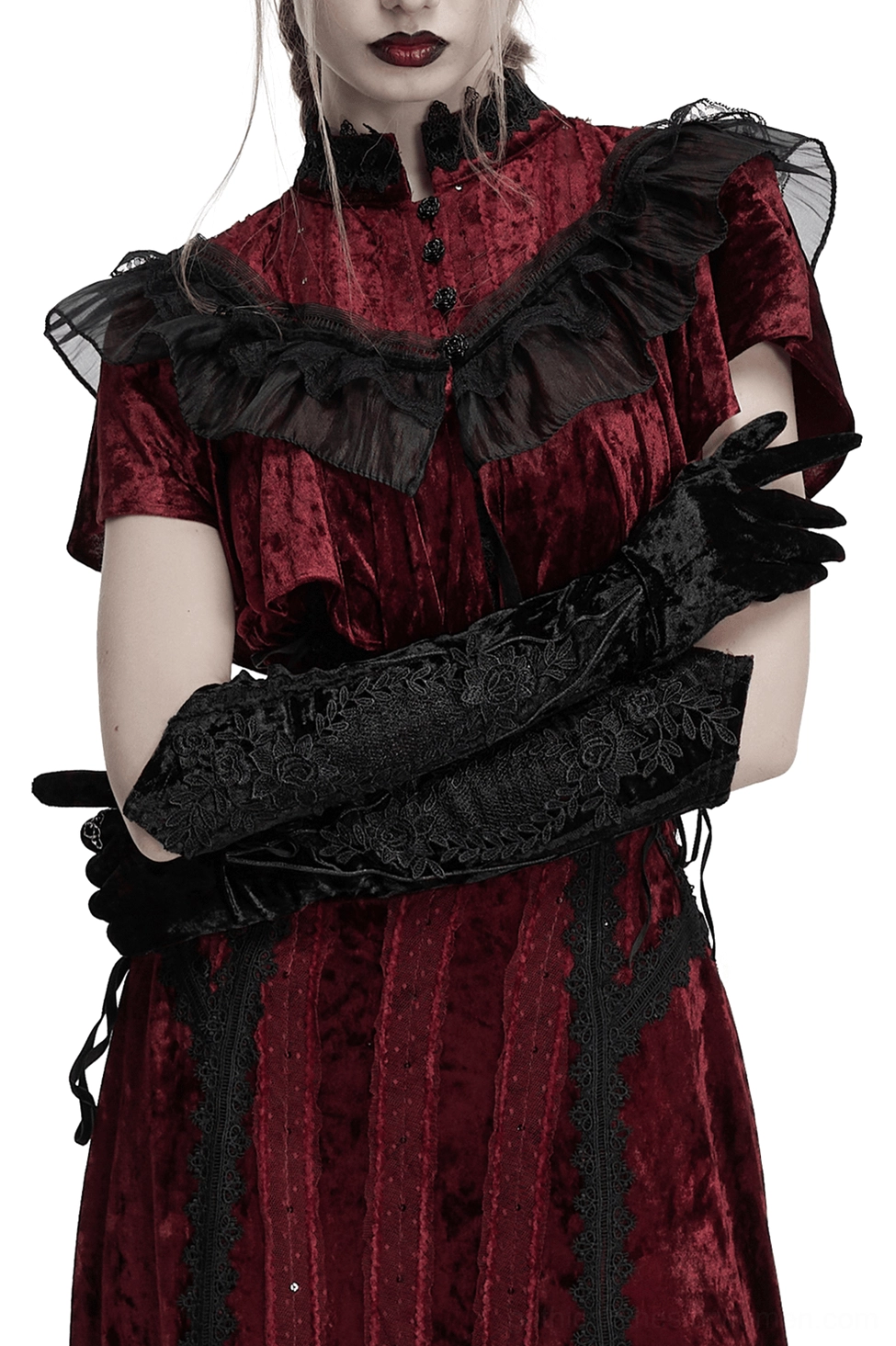 Gothic velvet arm gloves worn with black dress - three-quarter front view showing pointed cuffs and embroidery detail