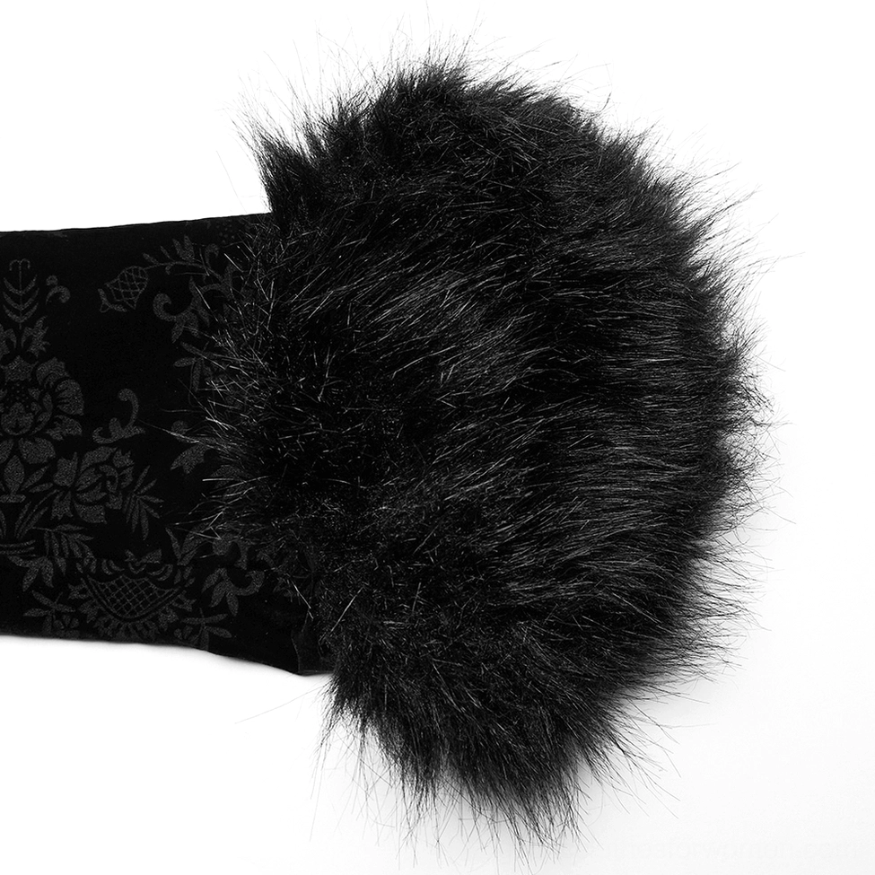 Black faux fur sleeve cuff close-up macro view showing texture and fluffy pile on velvet jacket