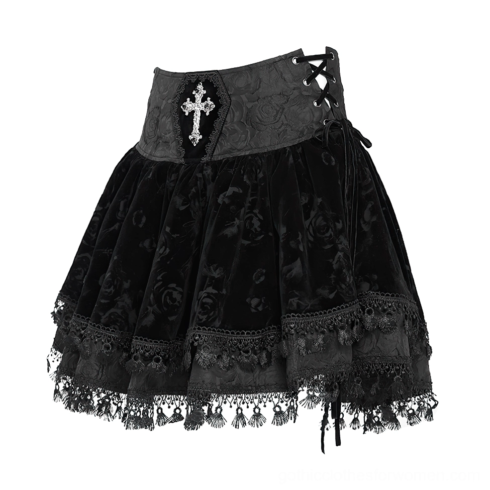 Front flat view of black velvet gothic skirt with side corset lace-up design, rose embossed velvet fabric, and layered tassel lace hem detail