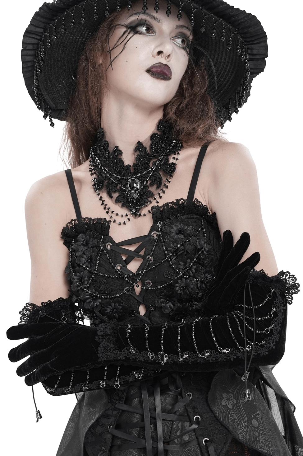 Black velvet opera gloves with lace cuffs and metal chain details worn on model, three-quarter front view showcasing the fitted silhouette and gothic elegance