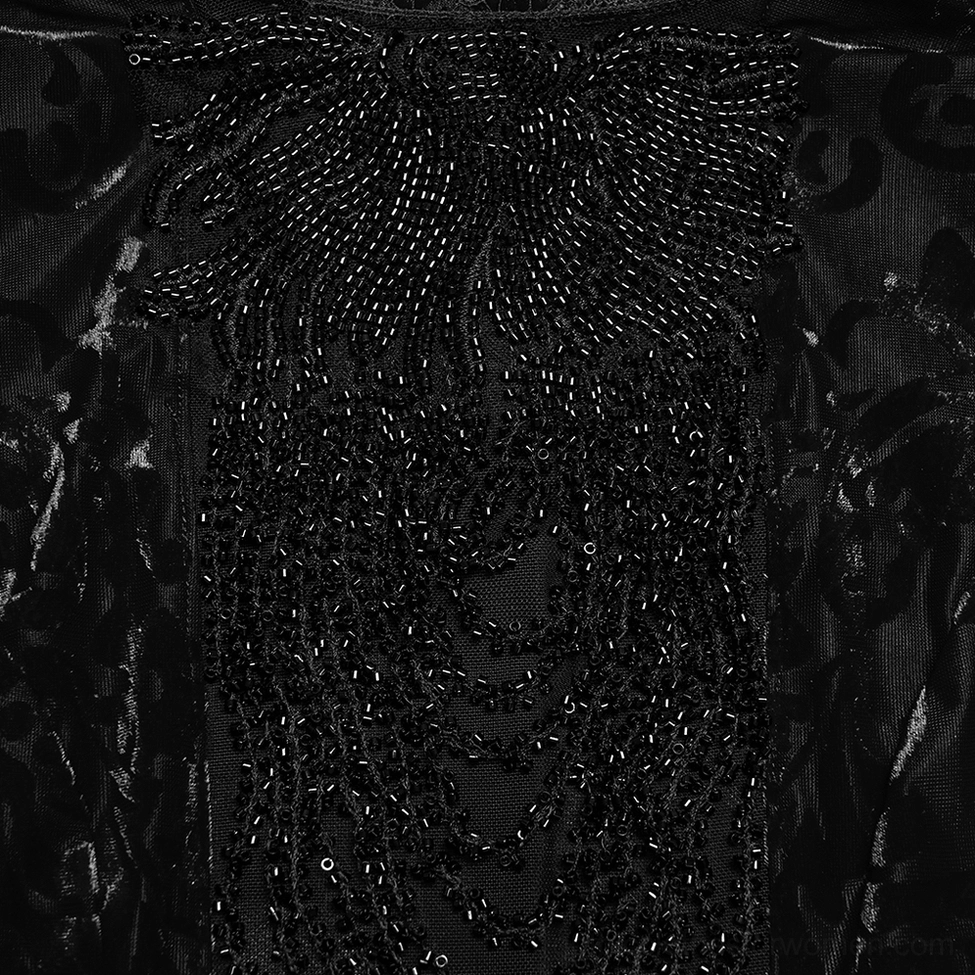 Close-up of beaded decoration and draped bead tassels on black velvet gothic top with sheer mesh base