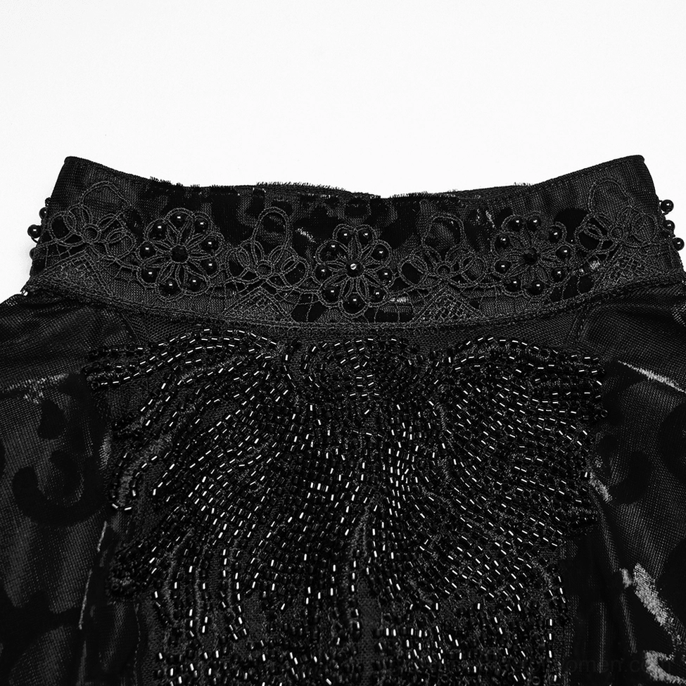 Close-up detail of black velvet gothic top collar and front trim showing intricate lace embroidery and beaded embellishment