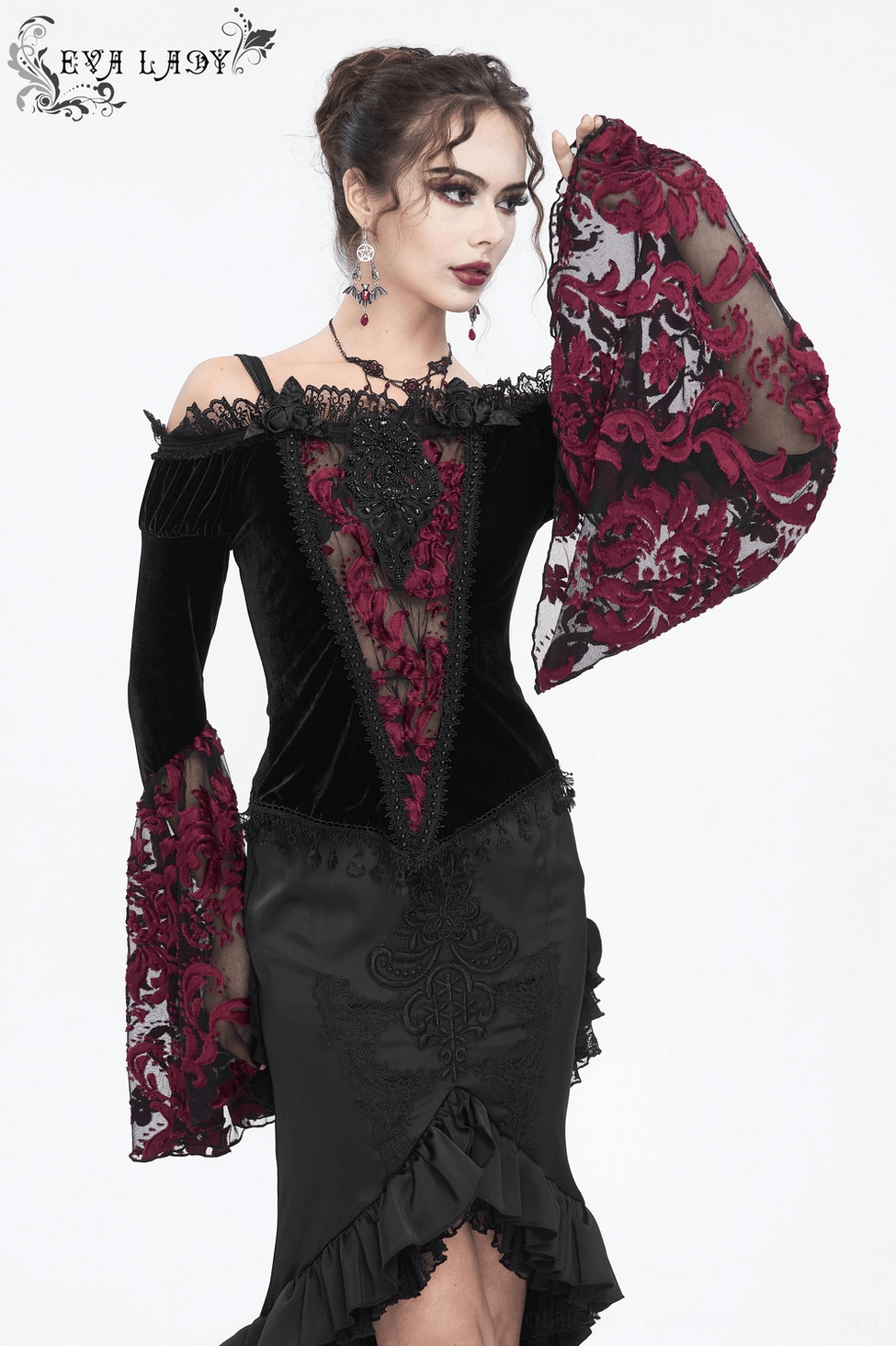 Front three-quarter fashion view of black velvet gothic top with dramatic flared lace sleeves