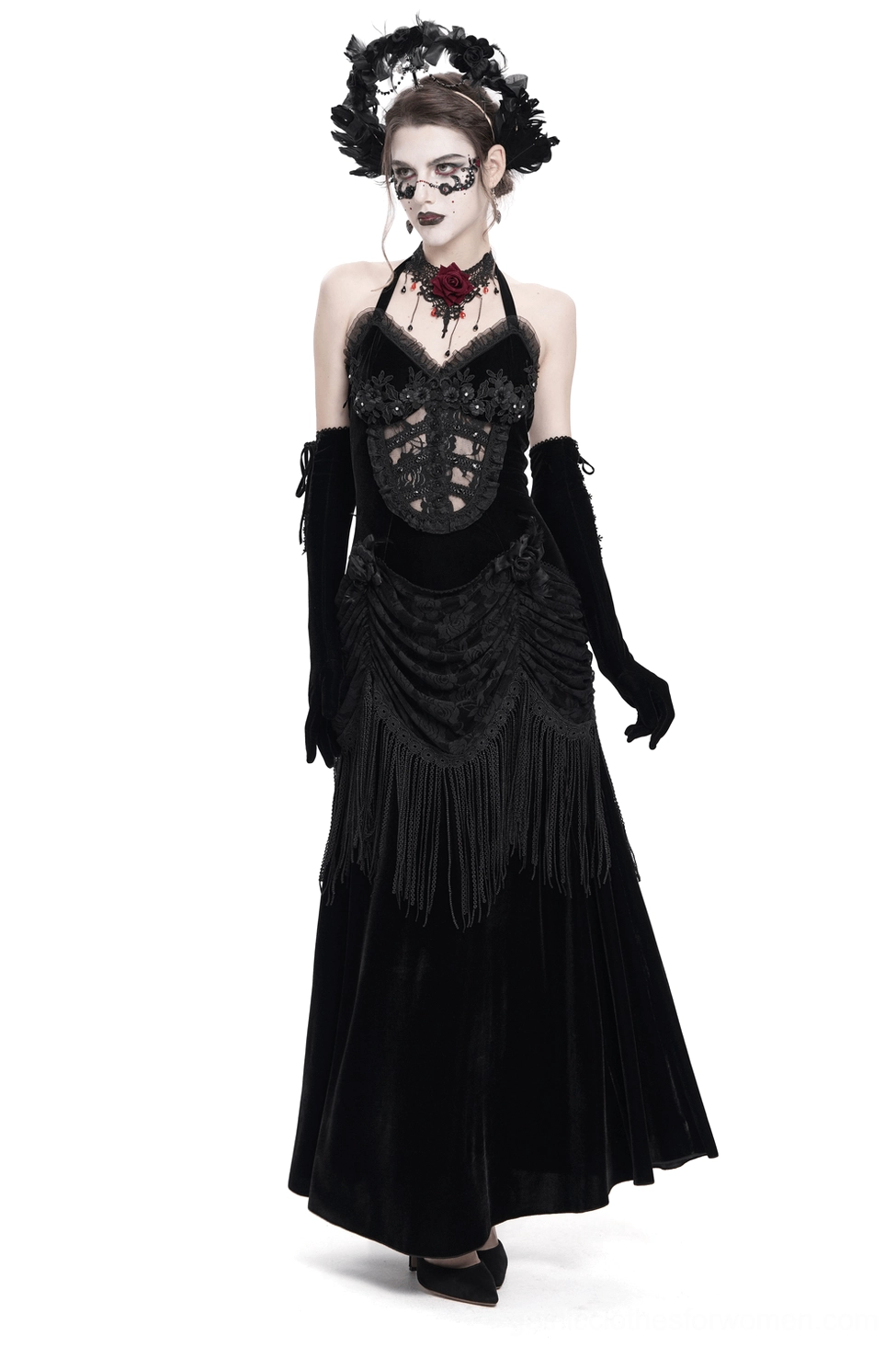 Black velvet gothic halter dress with lace bodice and fringe skirt, front three-quarter view on model with long gloves