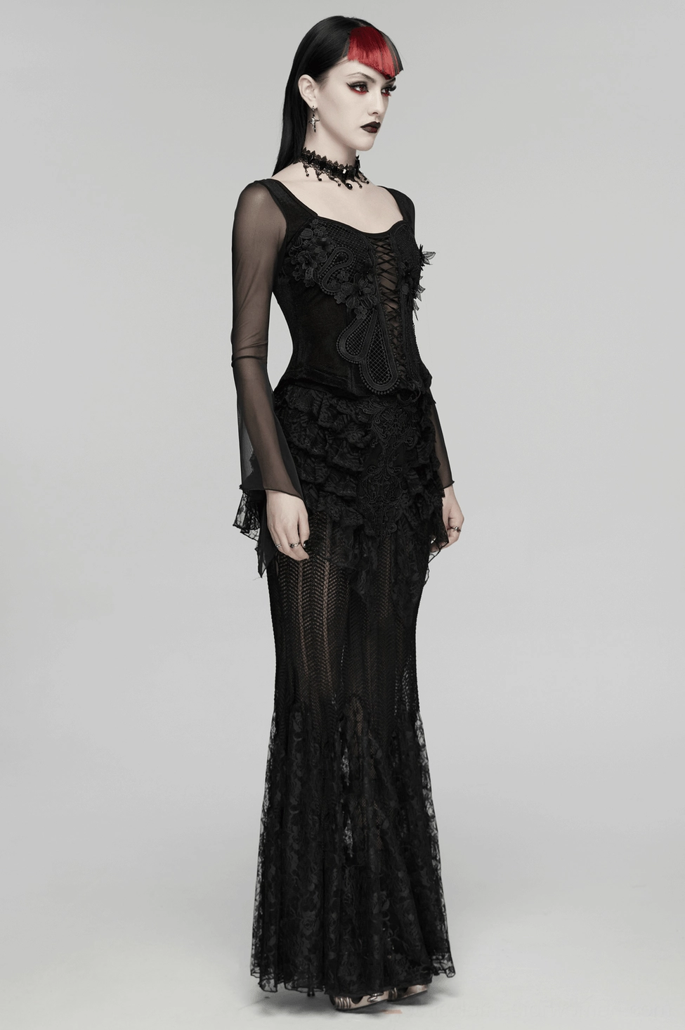 Full-length front view of model wearing black velvet lace-up mesh embroidery gothic top with floral details