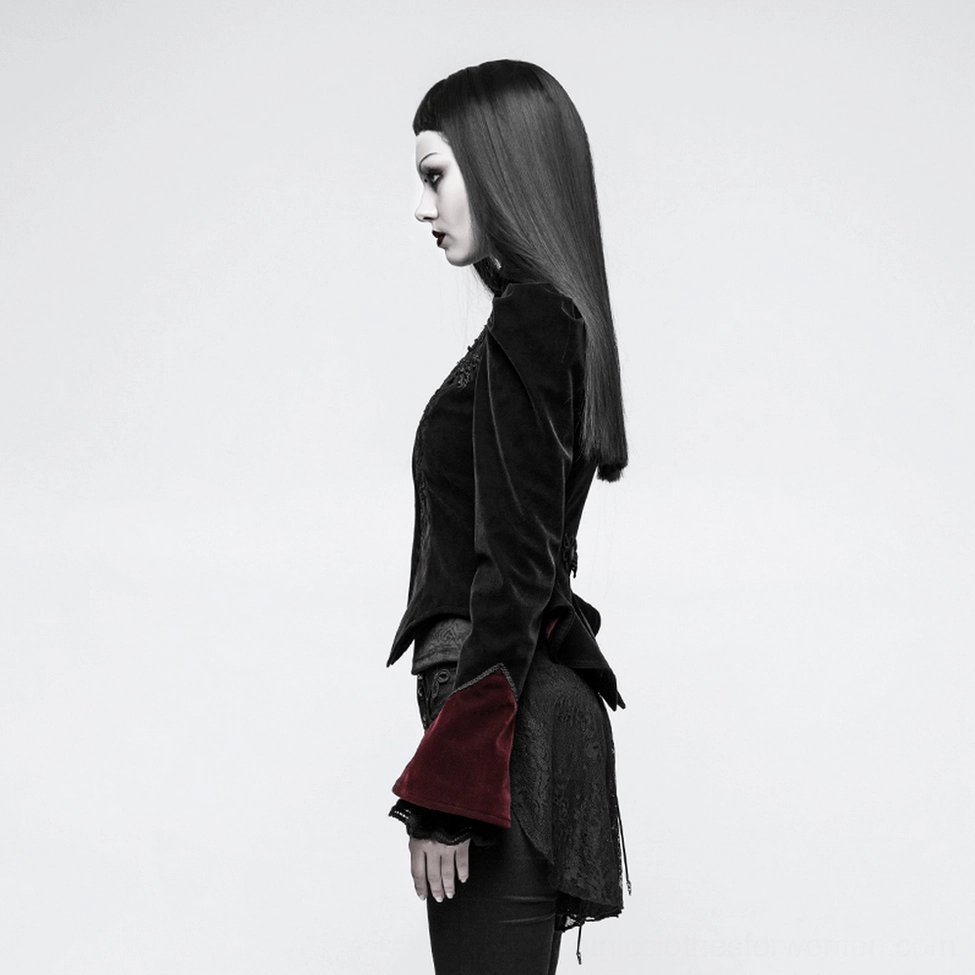 Side view of black velvet gothic tailcoat worn on model showing fitted back design and dark undergarment styling
