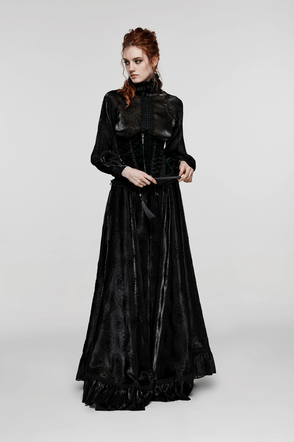 Black velveteen corset front view displaying symmetrical lace ribbon lacing, metal eyelets, embroidered lace hem, and Victorian-inspired design elements